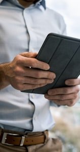 person holding black smart cover during daytime